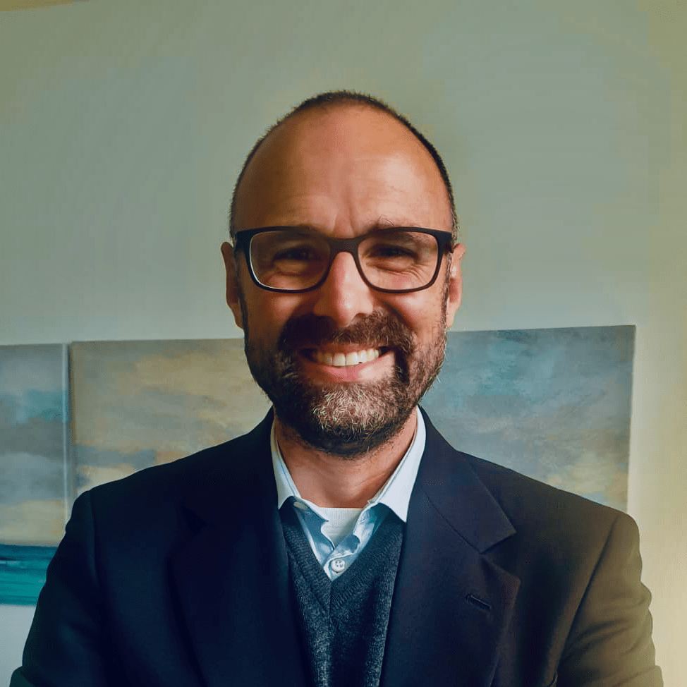 Italian CBT Therapist in Edinburgh for OCD & Anxiety. Federico Ferrarese wearing glasses and a suit